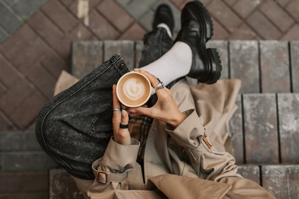 Hands holding a warm mug, representing a pause to reflect on career mindset.