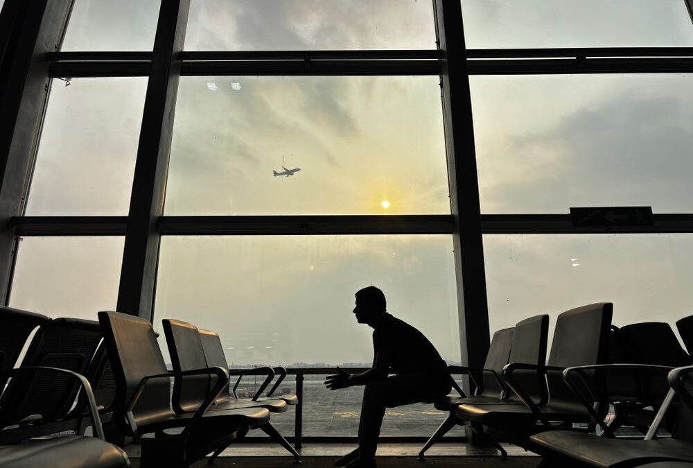 person sitting alone at airport waiting area