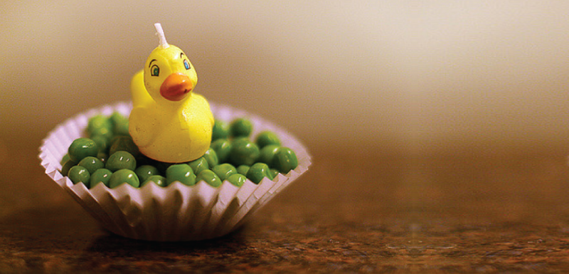 Duckie candle on a cupcake of peas