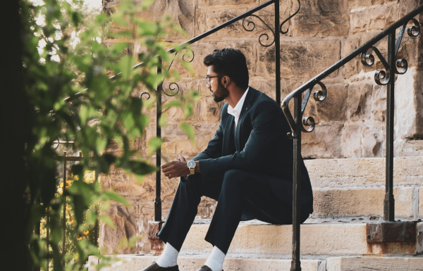 man sitting on stairs and contemplating